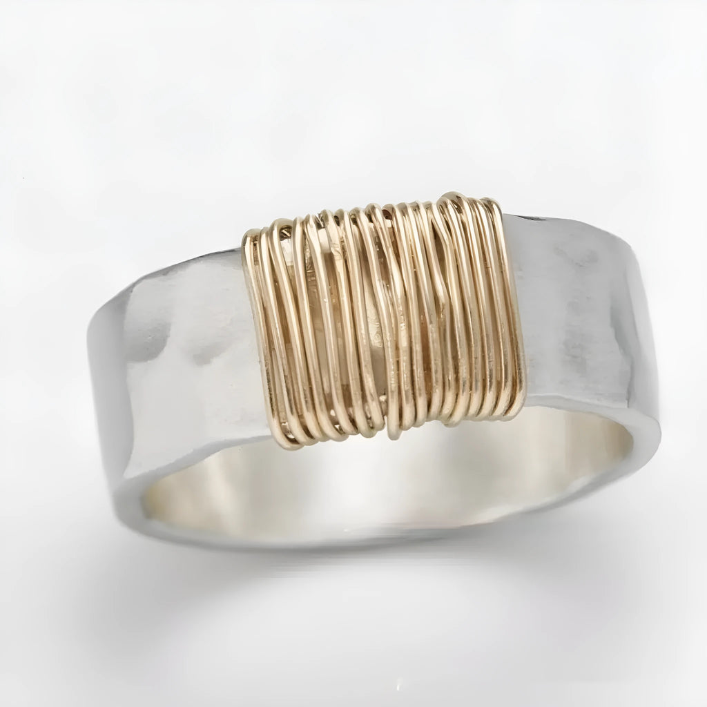 Copper wide face geometric ring bracelet in silver gold coil colour on a plain background.