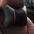 Green leather car headrest neck pillow with black red reversible colour, placed on a car seat for neck support