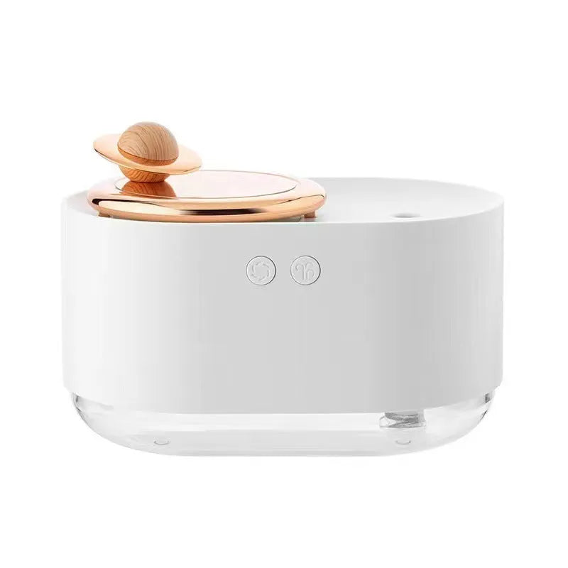 Green rotating planet USB humidifier with night light on a desk next to a laptop.