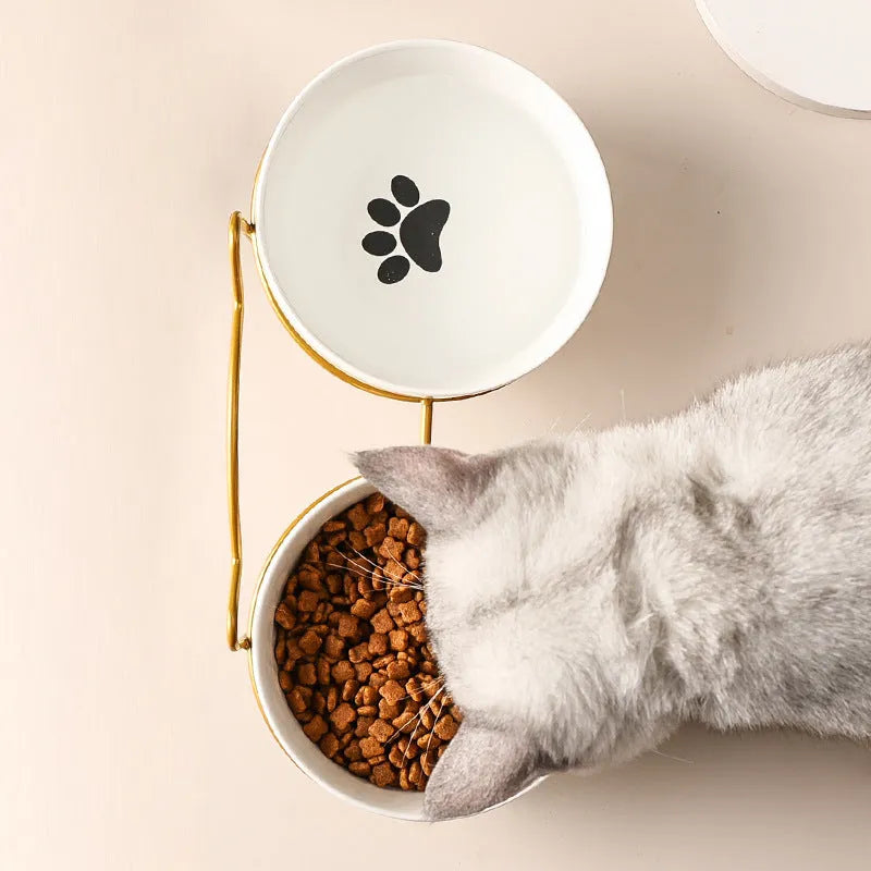 White ceramic pet bowl with cat footprints pattern in black iron frame with cat ears
