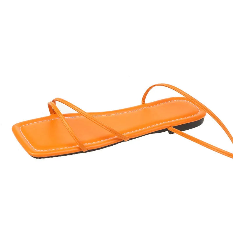 Women's flat sandals with ankle ring bandage strap and front lace-up fastening in square toe design.