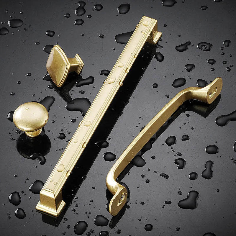 Gold aluminium alloy T‑shape single hole cabinet door handle.