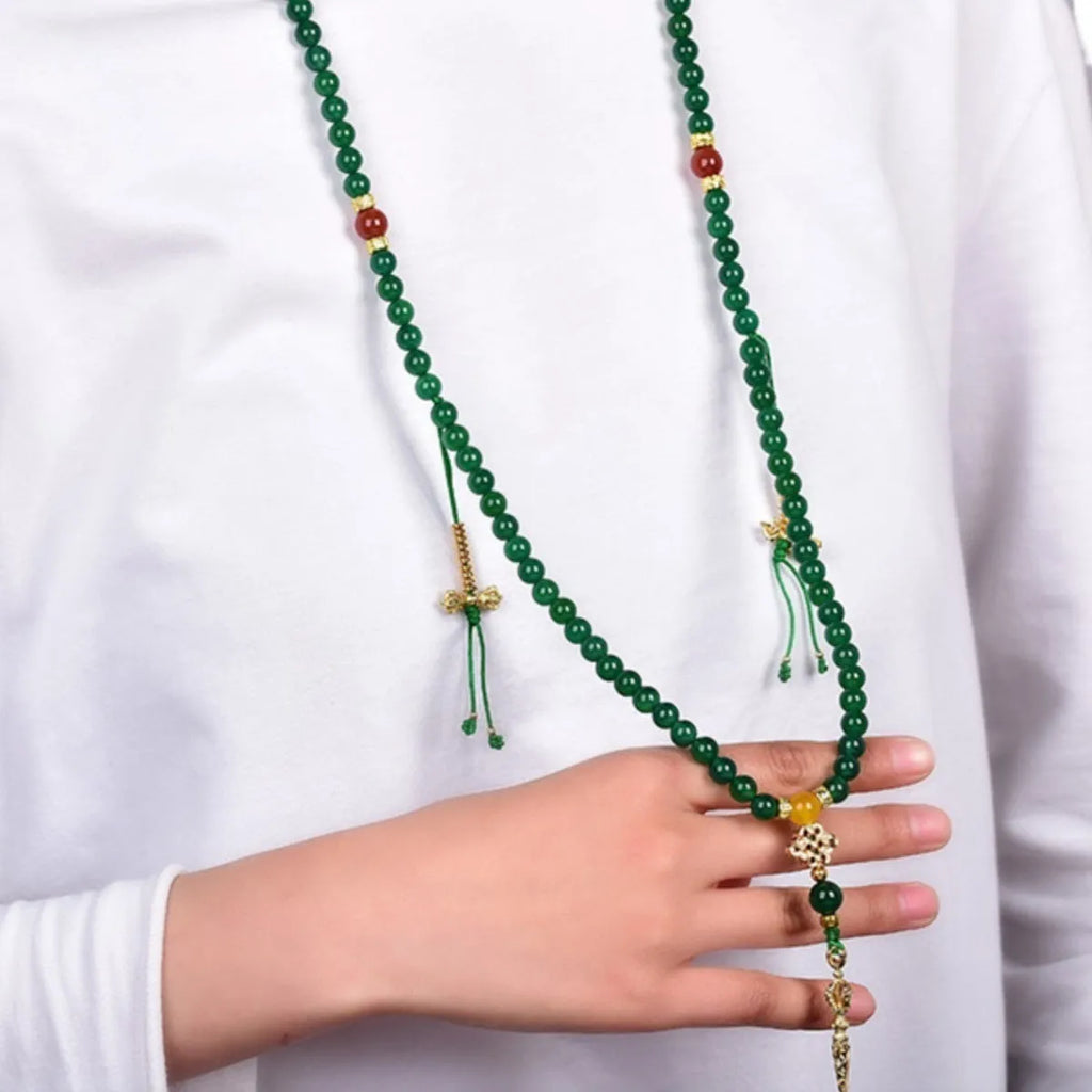 Close-up of a multi-circle green agate bracelet with natural stone beads on a wrist.