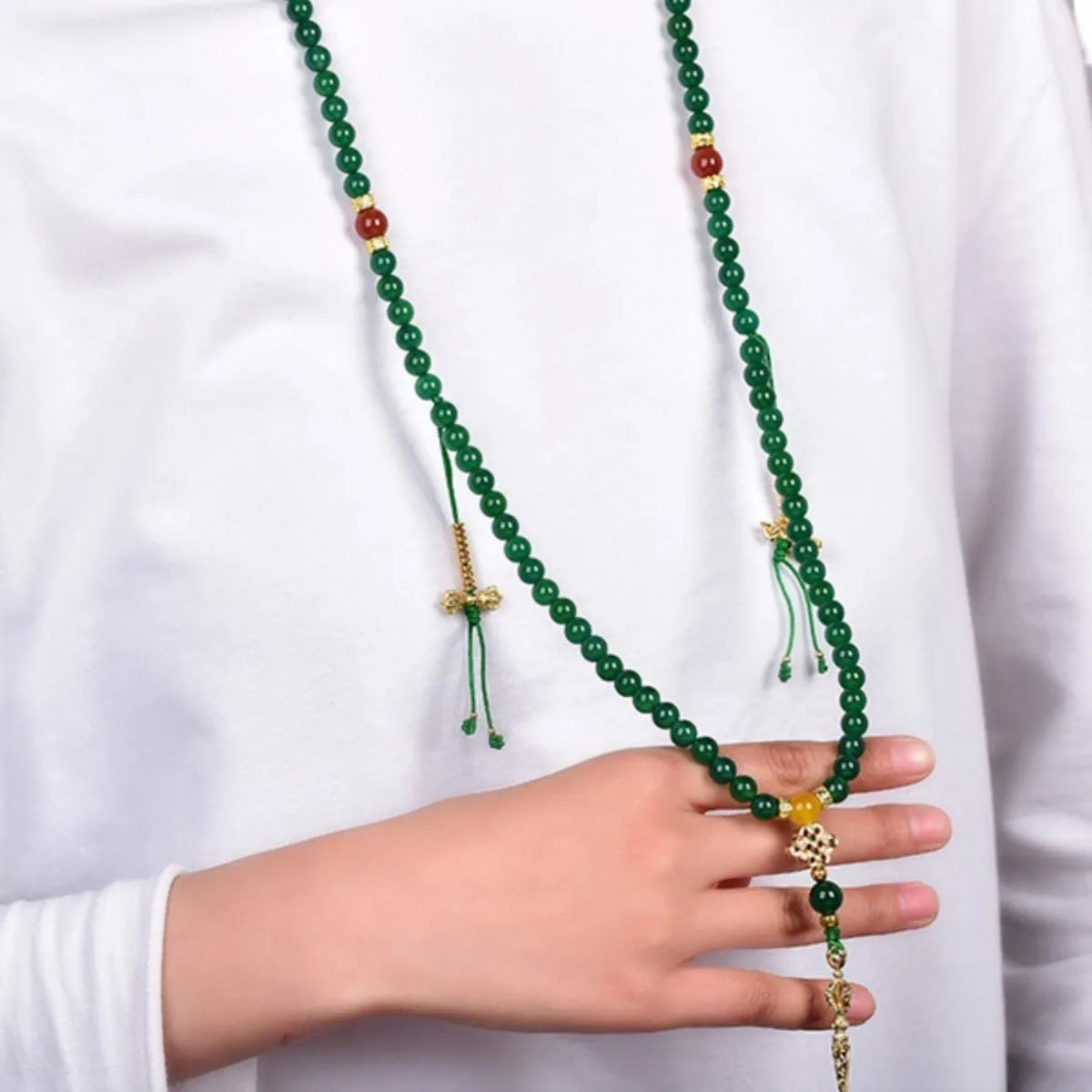 Close-up of a multi-circle green agate bracelet with natural stone beads on a wrist.