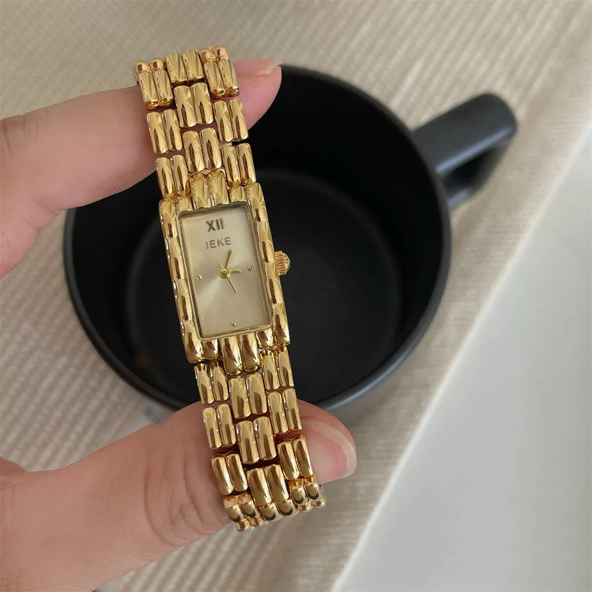 Bracelet-style silver and gold women's Ins watch showing 15mm dial and butterfly clasp.