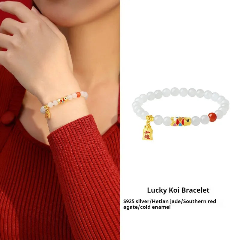 Close-up of a women's sterling silver bracelet with a koi fish cold enamel design and a natural Hetian jade component.