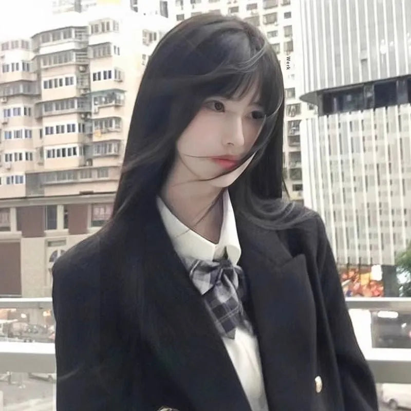 Long straight black synthetic wig with full blunt bangs on a wig stand.