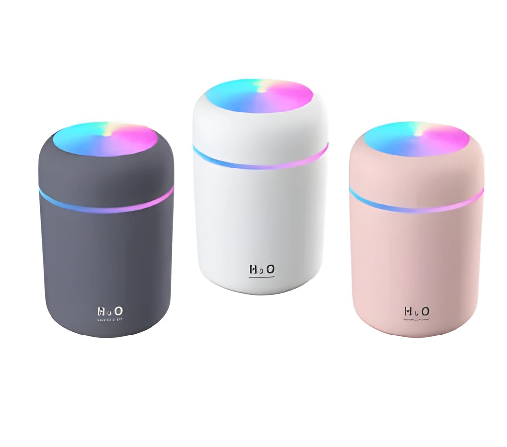 Mini ultrasonic essential oil diffuser with 300ml water tank in white, showing coloured night lights and USB cable
