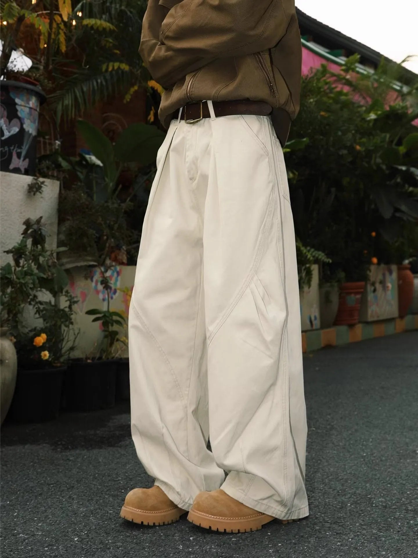Men's loose straight-leg pleated trousers in apricot stripes on a mid-waist fit model.