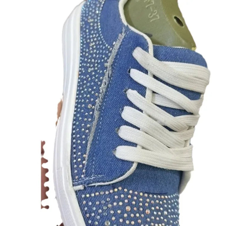 Women's black lace-up casual shoes with rhinestone detail and thick flat rubber sole.