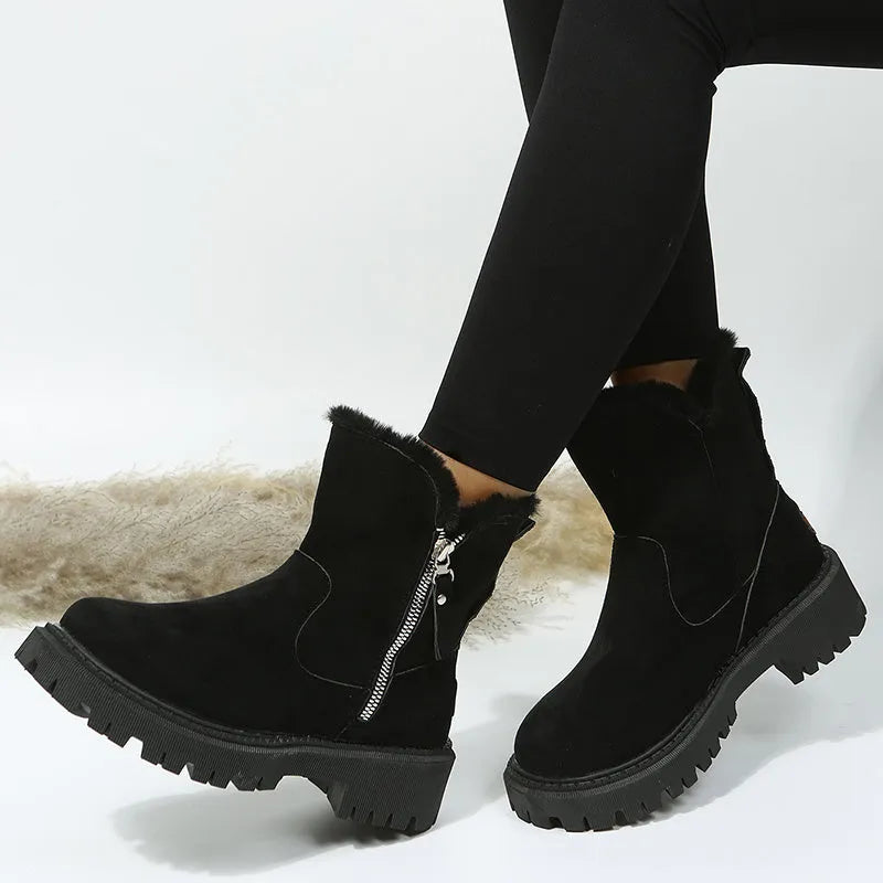 Women's black high-top snow boots with a side zipper and round toe on a non-slip rubber sole.