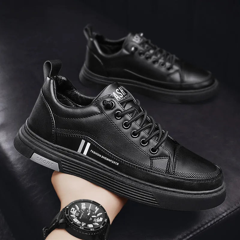 Men's low-top skate shoes in black with a round toe, elastic band, and rubber sole.