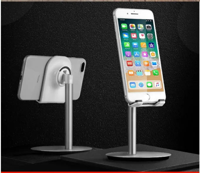 Silver metal desktop phone and tablet holder model S1 on a desk, showing a device held upright.