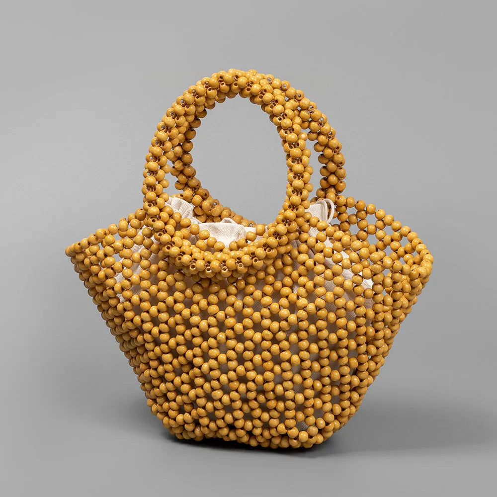 Hand-woven maple wood beach bag with wooden bead decoration in dumpling shape