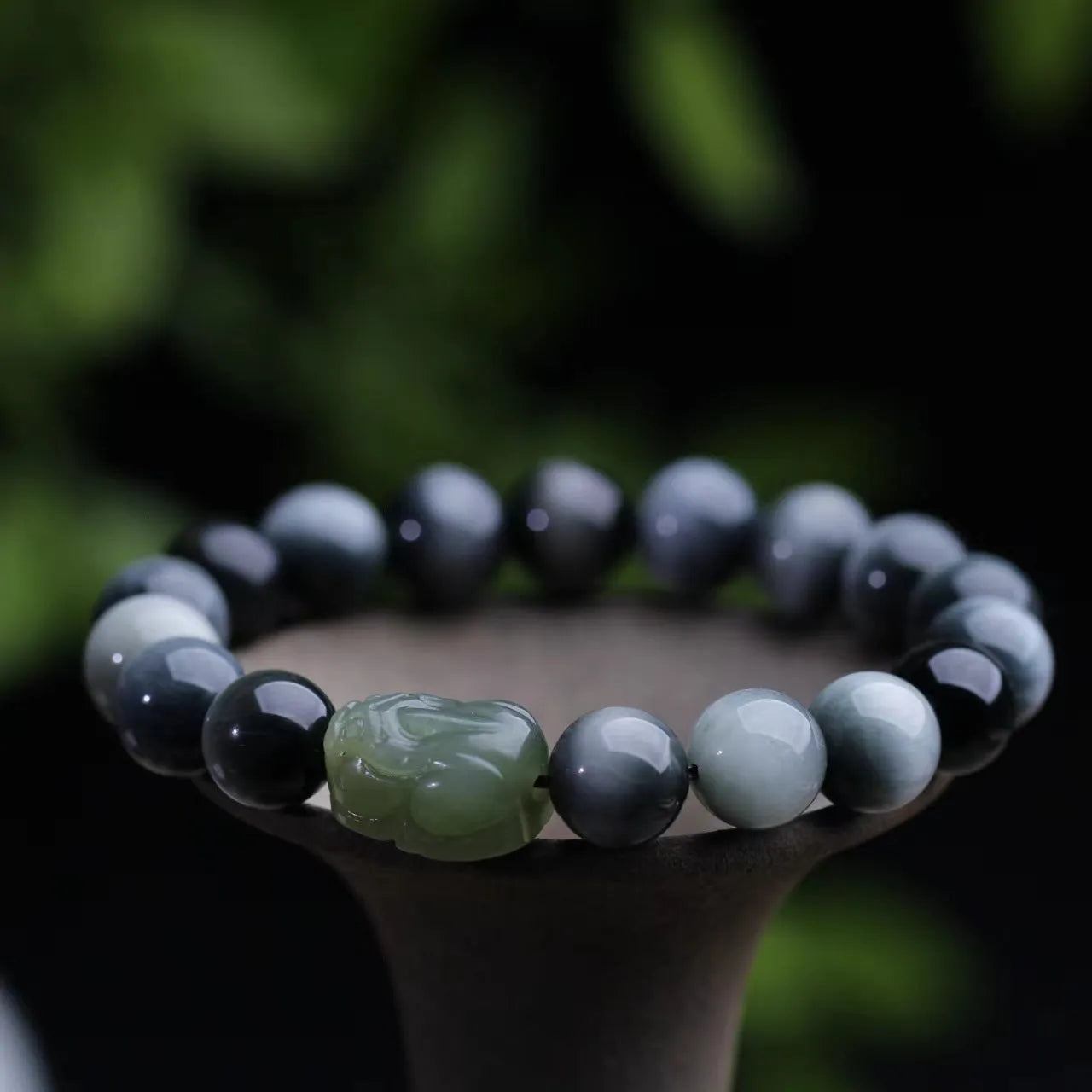 10mm Eagle Eye Stone bead bracelet with a natural Hetian Jade Clear Water Pixiu charm on a black cord.