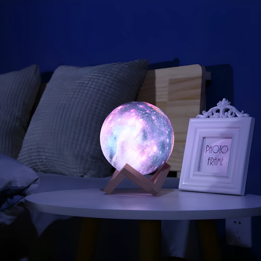 White spherical lunar night light with textured surface and glowing LED illumination on a dark surface.