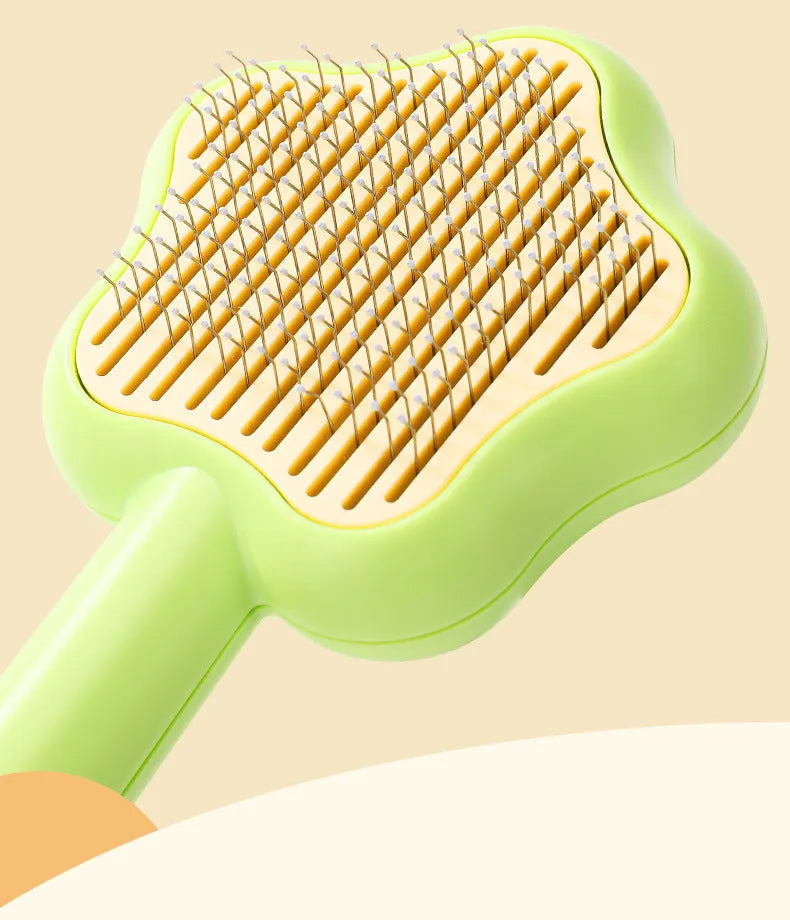 Green self-cleaning cat comb with four stainless steel needles measuring 20cm long