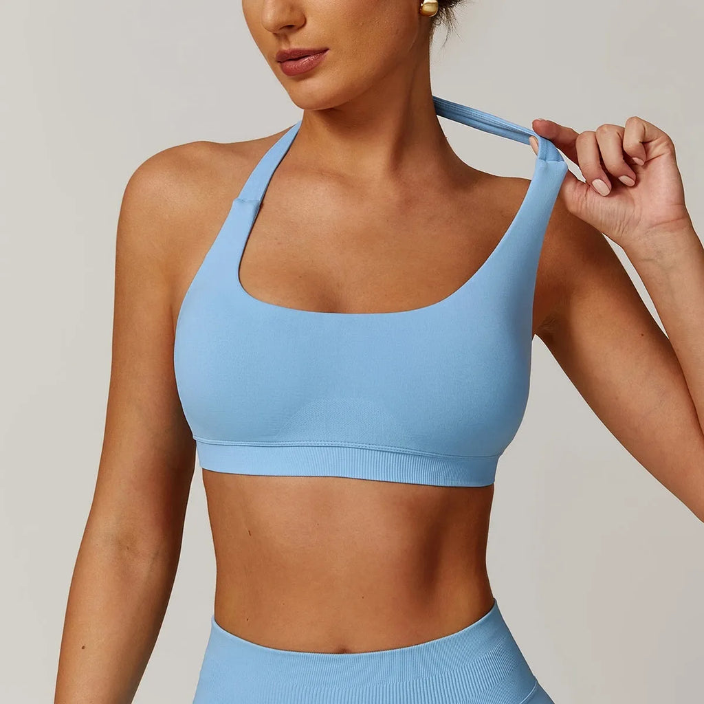 Women's black halter yoga bra with removable chest pad on a mannequin