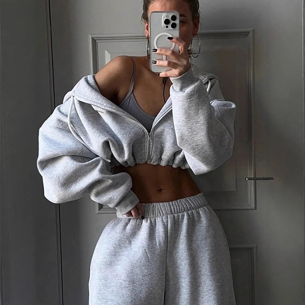 Long sleeve polyester sports suit two-piece set in light grey, shown as coat and trousers.
