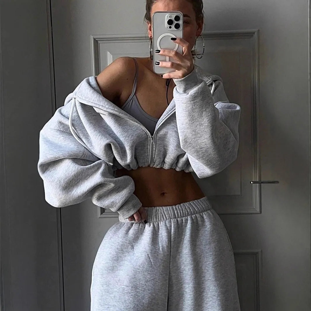 Long sleeve polyester sports suit two-piece set in light grey, shown as coat and trousers.