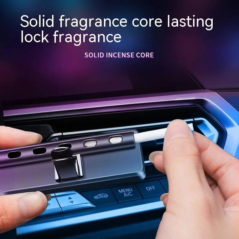 Black car air vent perfume diffuser with LED lighting mounted on vehicle dashboard