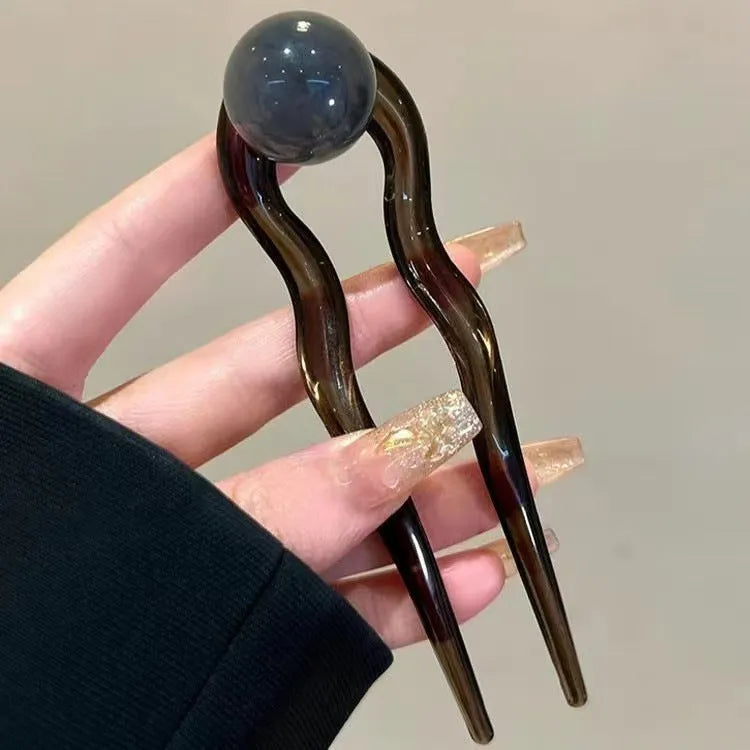 Acrylic U-shaped hair barrettes with ball decoration in beige, caramel, dark grey, and green colours
