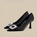 Women's pointed toe stiletto high heels in beige and black, showing low-cut design and thin heel.