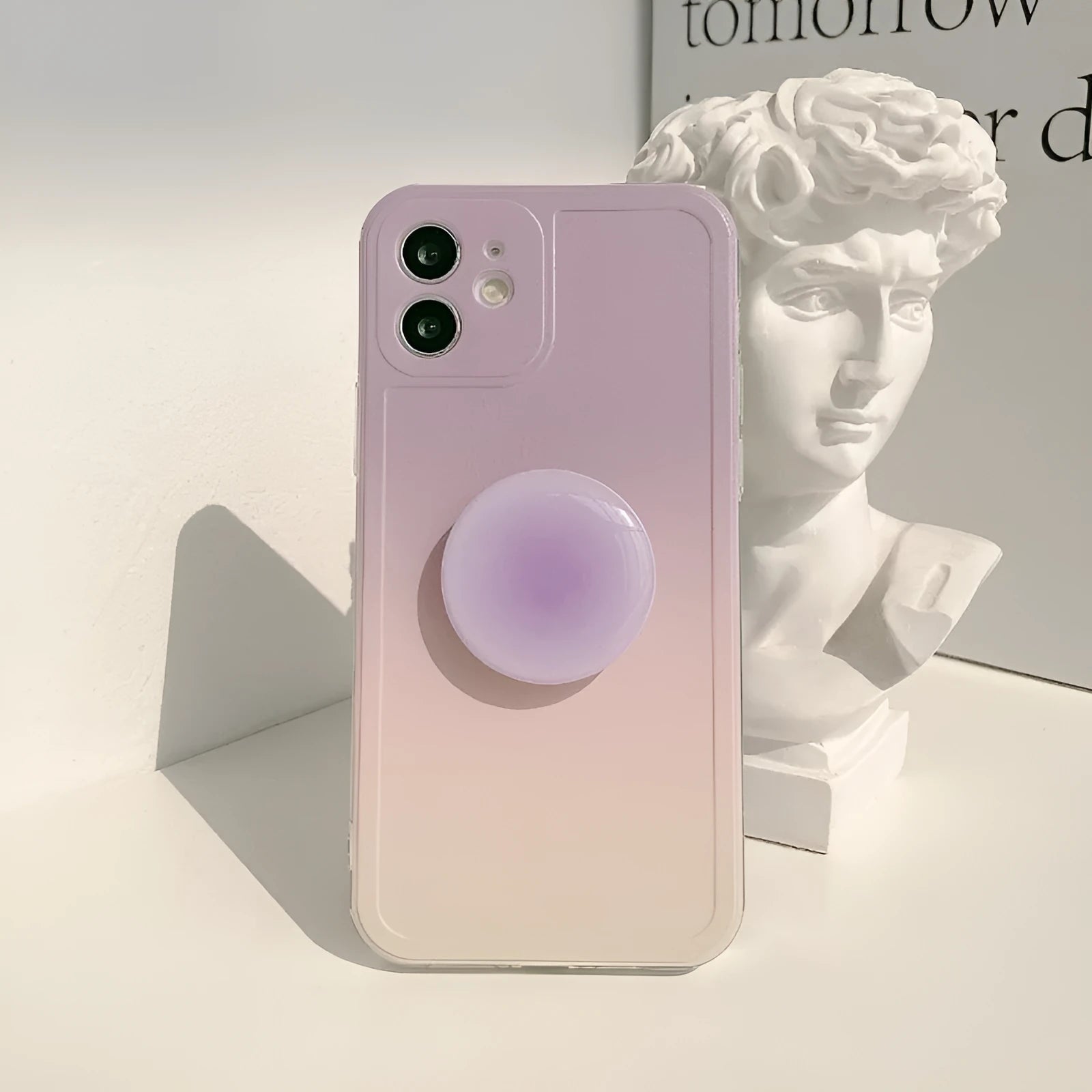 Yellow and purple gradient silicone iPhone case with a retractable viewing stand extended.