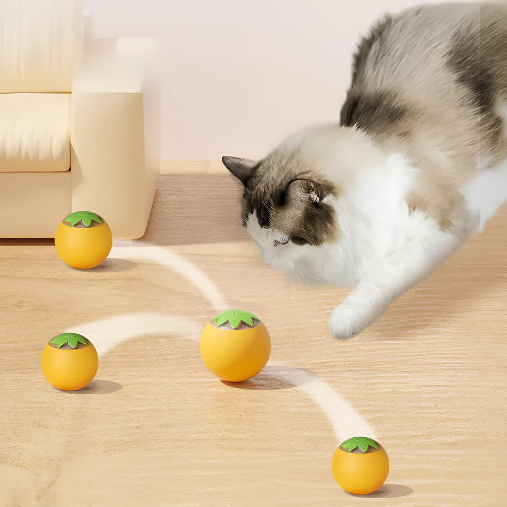 Green electric rolling ball pet toy for dogs and cats on a floor.