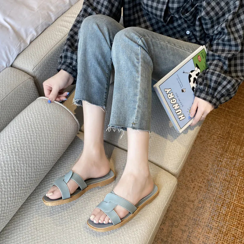 Women's PVC cross-strap toe ring sandals in light blue on a white background.