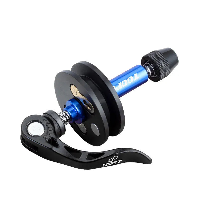 Aluminium bicycle chain holder tool for washing and tension measurement on a workbench.