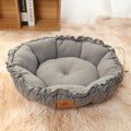 Grey donut-shaped cat bed with raised sides and reversible design