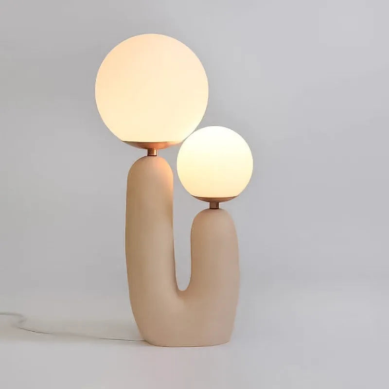 Pink double-head resin table lamp with glass shades on a bedside table, 49cm height