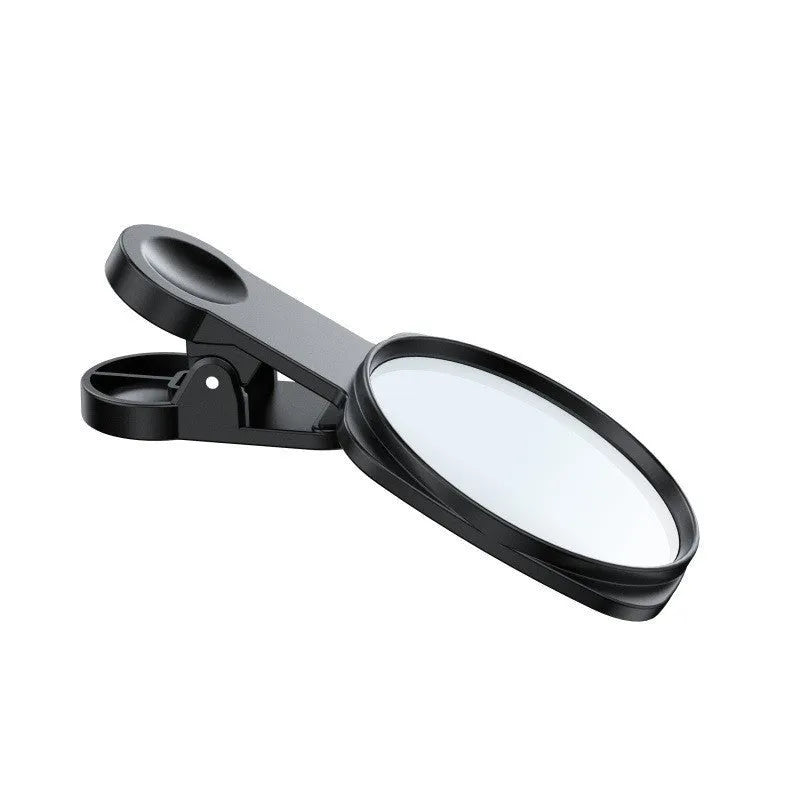 Black mobile phone rear camera self-timer mirror clip with plastic and glass construction, shown attached to a phone.
