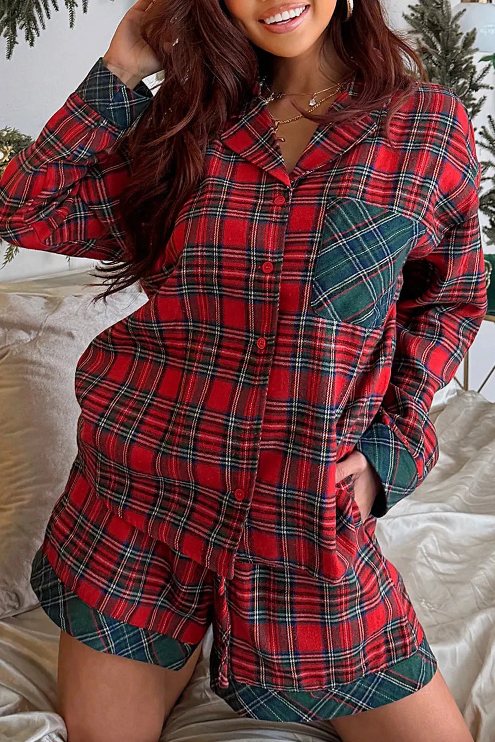 Red plaid Christmas pyjama set with contrasting fabric patches on shirt and shorts.