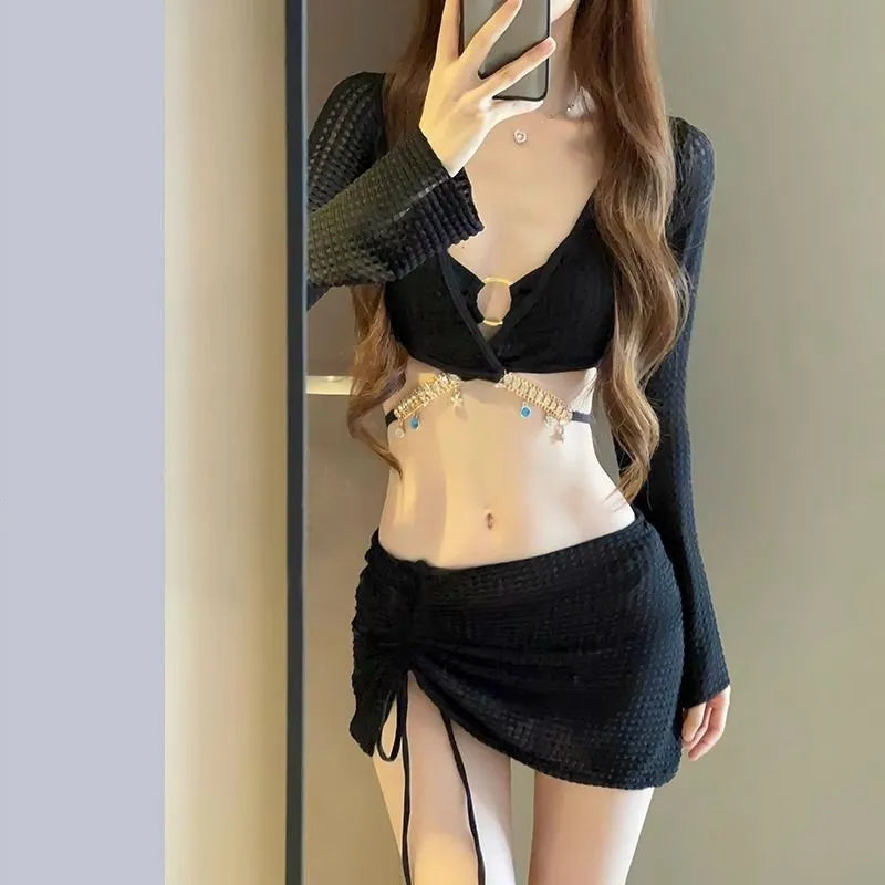 Women's long sleeve bikini swimsuit in black or white colours for swimming activities