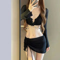 Women's long sleeve bikini swimsuit in black or white colours for swimming activities