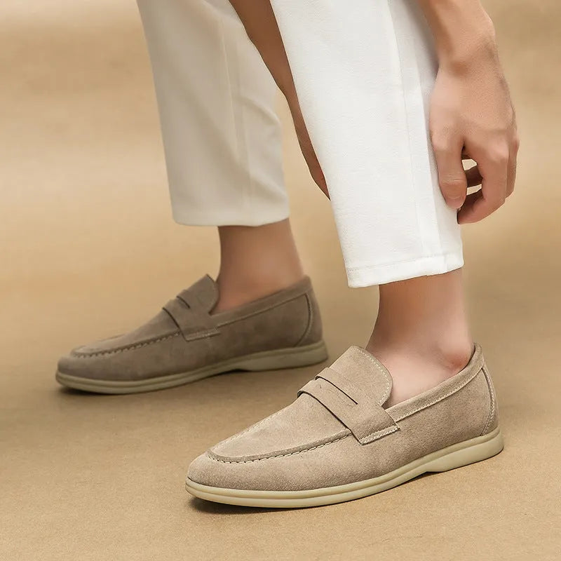 Men's beige leather slip-on casual shoes with a round toe and rubber sole on a white background.