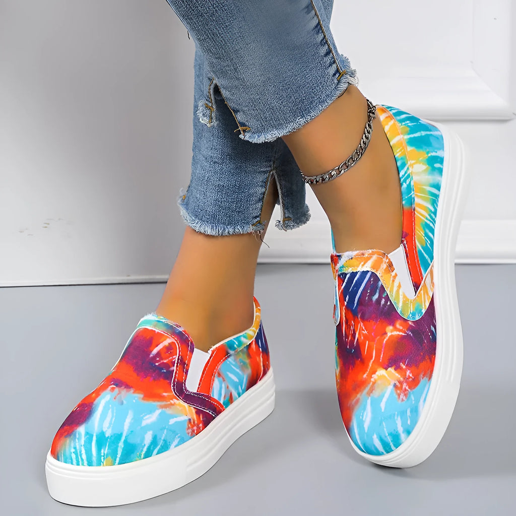 Women's blue colour match canvas trainers with flat rubber sole on a white background.