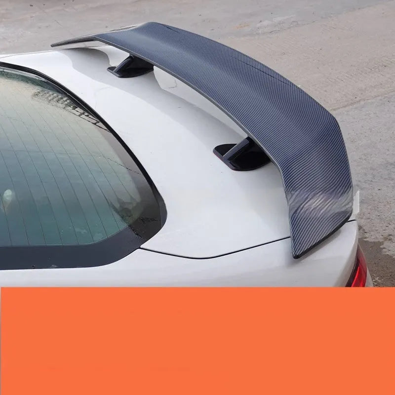Universal car punch-free tail wing spoiler in ABS plastic, showing bright black, bright white, and carbon pattern finish options.