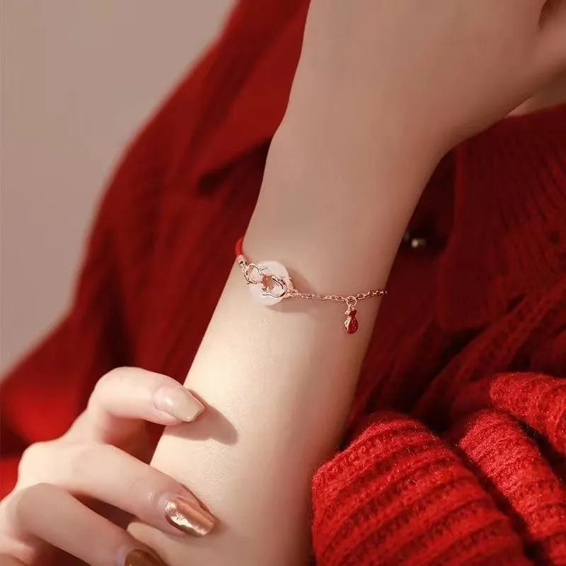 Festive koi bracelet with red rope design and peace buckle closure