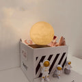 Magnetic levitation moon planet night light floating above base with astronaut decorations.