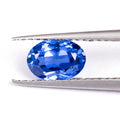 A single heart-shaped blue topaz loose gemstone on a plain background.