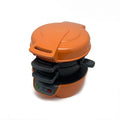 Bright red household breakfast machine sandwich toaster with egg cooker ring on a kitchen counter.