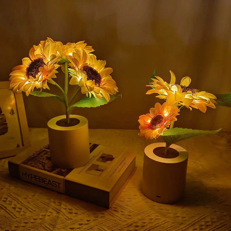 Rechargeable artificial sunflower LED night light on a table with USB cable.