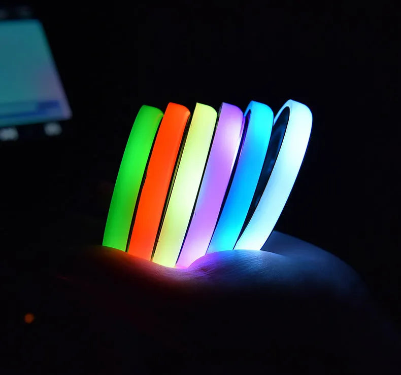 Colourful LED light-up coaster for car cup holder with USB cable, showing multiple light colours.