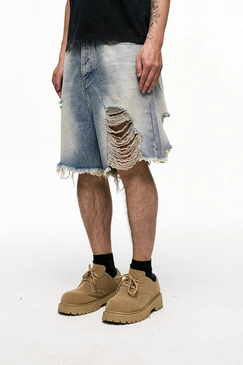 Light blue men's baggy denim shorts with a wide leg cut and mid waist on a plain background