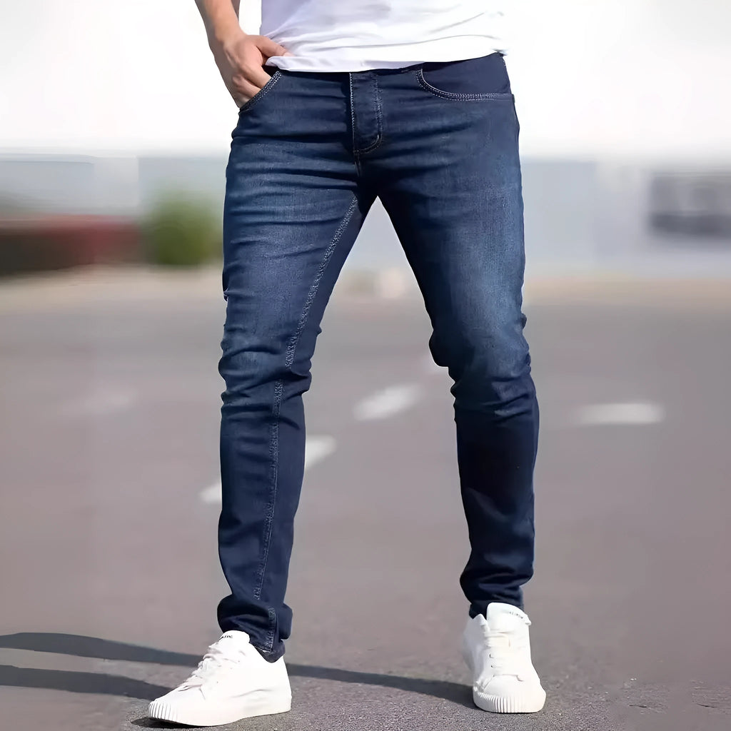 Men's slim-fit dark blue casual jeans with a worn wash and medium elastic cotton fabric.