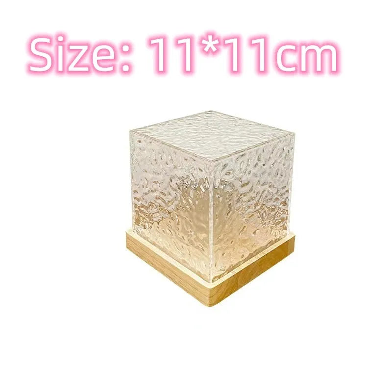 Water ripple crystal table lamp projecting coloured light patterns on wall