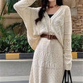 Beige two-piece set with hollowed-out knit top and mid-length lace-up skirt and belt